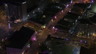 DX0002_188_014 - 5.7K aerial stock footage a busy Beale Street intersection at nighttime, Downtown Memphis, Tennessee