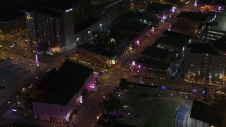 DX0002_188_015 - 5.7K aerial stock footage orbit and fly away from a busy Beale Street intersection at nighttime, Downtown Memphis, Tennessee