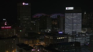 DX0002_188_022 - 5.7K aerial stock footage of city buildings between office towers at nighttime, Downtown Memphis, Tennessee