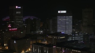 DX0002_188_023 - 5.7K aerial stock footage of flying away from an office tower at nighttime, Downtown Memphis, Tennessee