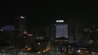 DX0002_188_024 - 5.7K aerial stock footage of a reverse view of an office tower at nighttime, Downtown Memphis, Tennessee