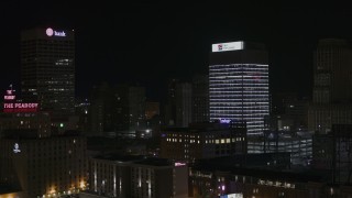 DX0002_188_026 - 5.7K aerial stock footage of fly away from First Tennessee Building at nighttime and descend, Downtown Memphis, Tennessee