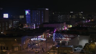 DX0002_188_027 - 5.7K aerial stock footage of orbiting the Beale Street sign at nighttime, Downtown Memphis, Tennessee