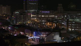 DX0002_188_030 - 5.7K aerial stock footage view of office complex, ascend to reveal the Beale Street sign at nighttime, Downtown Memphis, Tennessee