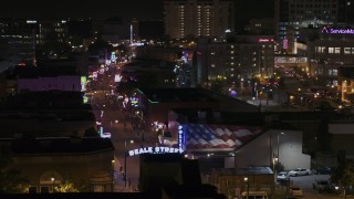 DX0002_188_031 - 5.7K aerial stock footage of circling the Beale Street sign at nighttime, Downtown Memphis, Tennessee
