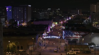 DX0002_188_034 - 5.7K aerial stock footage orbit the Beale Street sign for view down the street at nighttime, Downtown Memphis, Tennessee