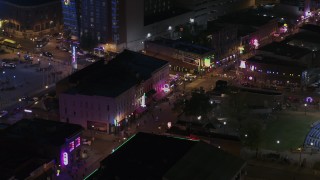 DX0002_188_037 - 5.7K aerial stock footage of circling clubs and restaurants on Beale Street at nighttime, Downtown Memphis, Tennessee