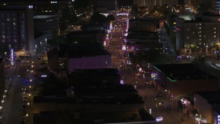 DX0002_188_038 - 5.7K aerial stock footage of flying by numerous Beale Street clubs and restaurants at nighttime, Downtown Memphis, Tennessee
