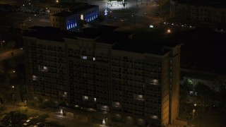 DX0002_188_042 - 5.7K aerial stock footage approach and fly away from an office building at nighttime, Memphis, Tennessee