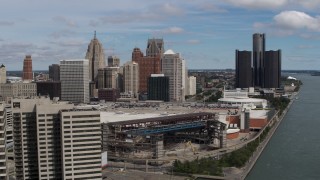 DX0002_189_007 - 5.7K aerial stock footage fly away from the arena and skyline, reveal apartment towers, Downtown Detroit, Michigan