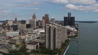 DX0002_189_008 - 5.7K aerial stock footage fly away from apartment towers with skyline in the distance, Downtown Detroit, Michigan