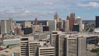 DX0002_189_012 - 5.7K aerial stock footage fly away skyline, reveal apartment towers, Downtown Detroit, Michigan