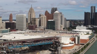DX0002_189_018 - 5.7K aerial stock footage reverse view of skyline, reveal arena and apartment towers, Downtown Detroit, Michigan