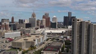 DX0002_189_023 - 5.7K aerial stock footage of skyscrapers seen while descending by apartment complex in Downtown Detroit, Michigan
