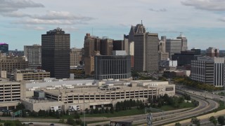 DX0002_190_003 - 5.7K aerial stock footage ascend past hotel with view of skyscrapers, Downtown Detroit, Michigan