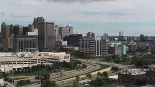 DX0002_190_013 - 5.7K aerial stock footage reverse view of hotel and police headquarters, Downtown Detroit, Michigan