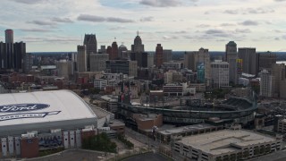DX0002_191_007 - 5.7K aerial stock footage flying by baseball and football stadiums with view of skyline, Downtown Detroit, Michigan