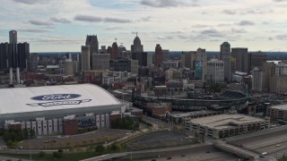 DX0002_191_008 - 5.7K aerial stock footage flying by football and baseball stadiums with view of skyline, Downtown Detroit, Michigan