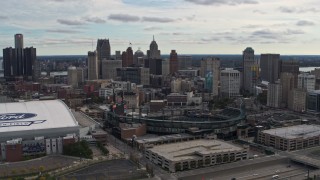 DX0002_191_009 - 5.7K aerial stock footage flying by Comerica Park with view of skyline, reveal Ford Field, Downtown Detroit, Michigan