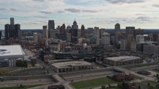 DX0002_191_013 - 5.7K aerial stock footage a reverse view of Comerica Park baseball stadium and skyline, Downtown Detroit, Michigan