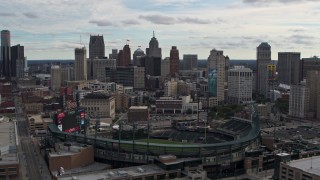 DX0002_191_015 - 5.7K aerial stock footage of descending by Comerica Park baseball stadium and skyline, Downtown Detroit, Michigan