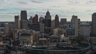 DX0002_191_020 - 5.7K aerial stock footage of the downtown skyline while flying by baseball stadium, Downtown Detroit, Michigan