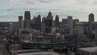 DX0002_191_021 - 5.7K aerial stock footage of the downtown skyline while passing by baseball stadium, Downtown Detroit, Michigan