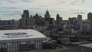 DX0002_191_022 - 5.7K aerial stock footage of the downtown skyline while passing by baseball and football stadiums, Downtown Detroit, Michigan