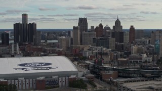 DX0002_191_025 - 5.7K aerial stock footage focus on the downtown skyline while flying by Comerica Park and Ford Field, Downtown Detroit, Michigan