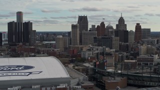 DX0002_191_026 - 5.7K aerial stock footage focus on downtown skyline while passing Ford Field and Comerica Park, Downtown Detroit, Michigan