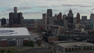 DX0002_191_030 - 5.7K aerial stock footage reverse view of skyline and Comerica Park, reveal Ford Field, Downtown Detroit, Michigan