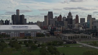DX0002_191_033 - 5.7K aerial stock footage flying away from stadiums with view of the skyline in Downtown Detroit, Michigan