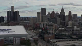 DX0002_191_034 - 5.7K aerial stock footage approach stadiums, ascend with view of the skyline in Downtown Detroit, Michigan