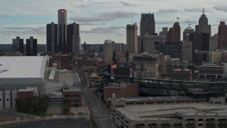 DX0002_191_035 - 5.7K aerial stock footage descend past stadiums, focus on the skyline in Downtown Detroit, Michigan