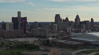 DX0002_191_037 - 5.7K aerial stock footage fly away from the skyline at sunset in Downtown Detroit, Michigan, reveal Ford Field