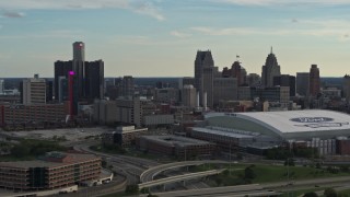 DX0002_191_038 - 5.7K aerial stock footage fly near football stadium and focus on the skyline at sunset in Downtown Detroit, Michigan