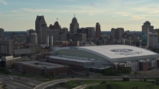 DX0002_191_040 - 5.7K aerial stock footage of the football stadium and the city skyline at sunset in Downtown Detroit, Michigan