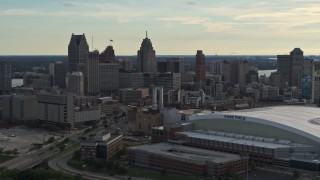 DX0002_191_044 - 5.7K aerial stock footage of a stationary view of the football stadium and the city skyline at sunset in Downtown Detroit, Michigan