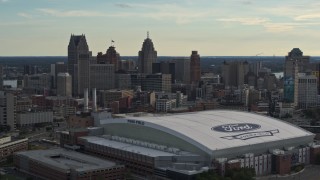DX0002_191_045 - 5.7K aerial stock footage flyby Ford Field football stadium and the city skyline at sunset in Downtown Detroit, Michigan