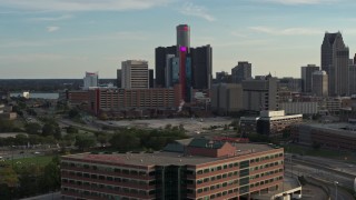 DX0002_191_049 - 5.7K aerial stock footage of tall skyscrapers and a hotel at sunset in Downtown Detroit, Michigan