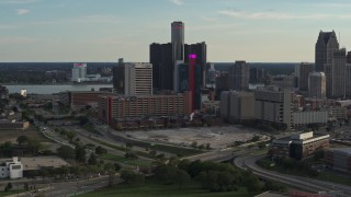 DX0002_191_051 - 5.7K aerial stock footage a view of tall skyscrapers and a hotel at sunset while descending in Downtown Detroit, Michigan