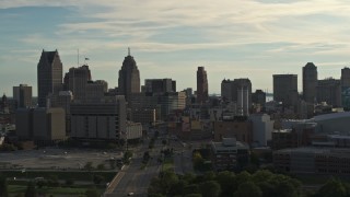 DX0002_192_004 - 5.7K aerial stock footage of flying by the city skyline at sunset in Downtown Detroit, Michigan
