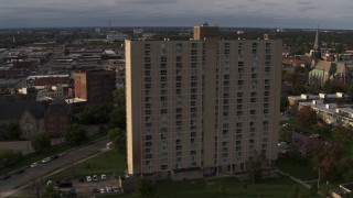 DX0002_192_012 - 5.7K aerial stock footage slowly orbit the City Place Detroit apartment building at sunset, Detroit, Michigan