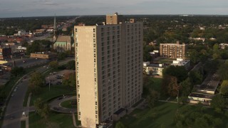 DX0002_192_013 - 5.7K aerial stock footage orbit side of the City Place Detroit apartment building at sunset, Detroit, Michigan