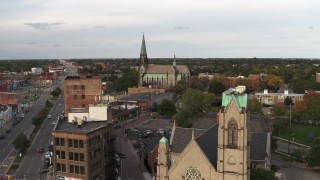 DX0002_192_019 - 5.7K aerial stock footage of a view of a church at sunset, Detroit, Michigan