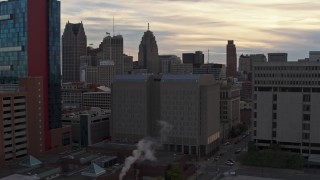 DX0002_192_021 - 5.7K aerial stock footage of orbiting the Wayne County Jail Division 1 building at sunset, Downtown Detroit, Michigan