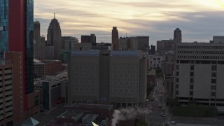 DX0002_192_022 - 5.7K aerial stock footage of a stationary view of the Wayne County Jail Division 1 building at sunset, Downtown Detroit, Michigan