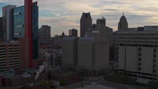 DX0002_192_023 - 5.7K aerial stock footage of an orbit of the Wayne County Jail Division 1 building at sunset, Downtown Detroit, Michigan