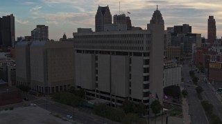 DX0002_192_024 - 5.7K aerial stock footage of the Frank Murphy Hall of Justice courthouse at sunset, Downtown Detroit, Michigan