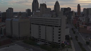 DX0002_192_028 - 5.7K stock footage aerial of the Frank Murphy Hall of Justice while ascending at sunset, Downtown Detroit, Michigan